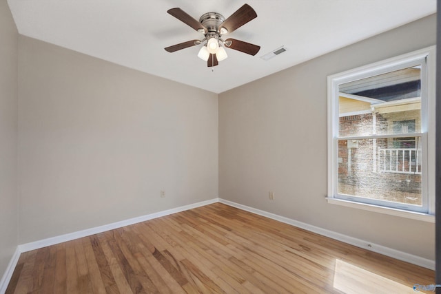 unfurnished room featuring visible vents, ceiling fan, light wood-type flooring, and baseboards