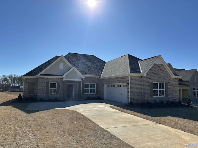 view of front facade with a garage, brick siding, and concrete driveway