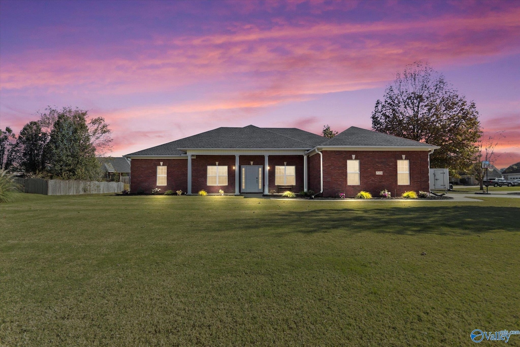 ranch-style home with a yard