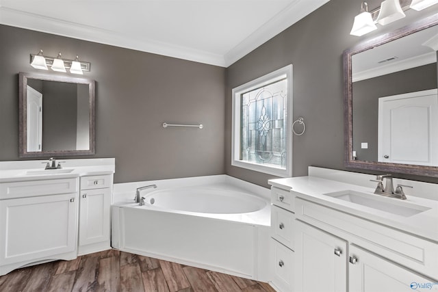 bathroom featuring vanity, a tub, ornamental molding, and wood-type flooring