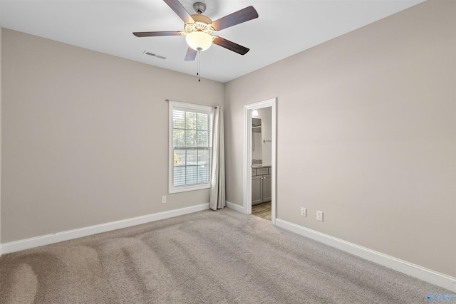 unfurnished room with ceiling fan and light colored carpet