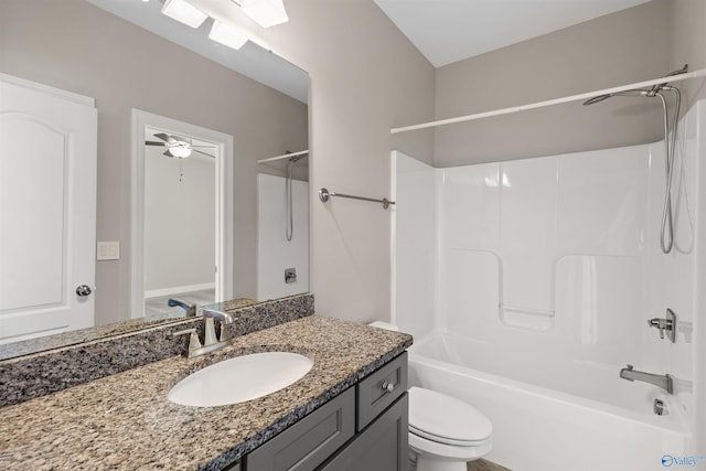 full bathroom featuring ceiling fan, vanity, toilet, and  shower combination