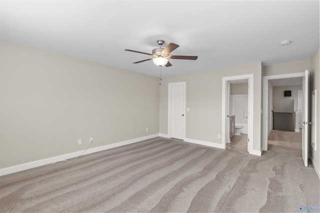 unfurnished bedroom with light carpet, ceiling fan, and connected bathroom