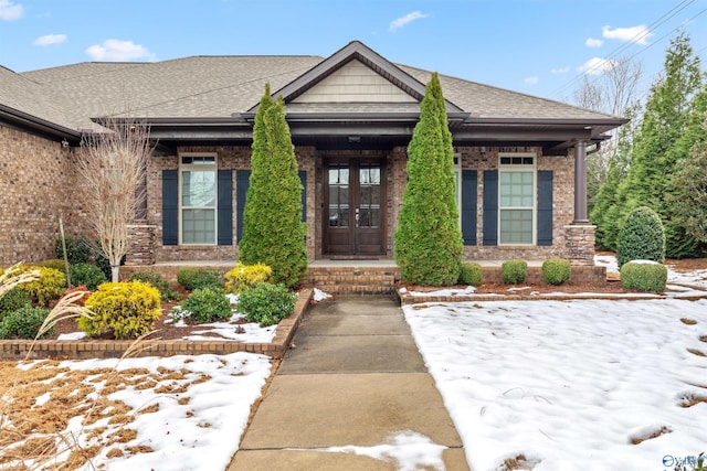 view of snow covered property entrance