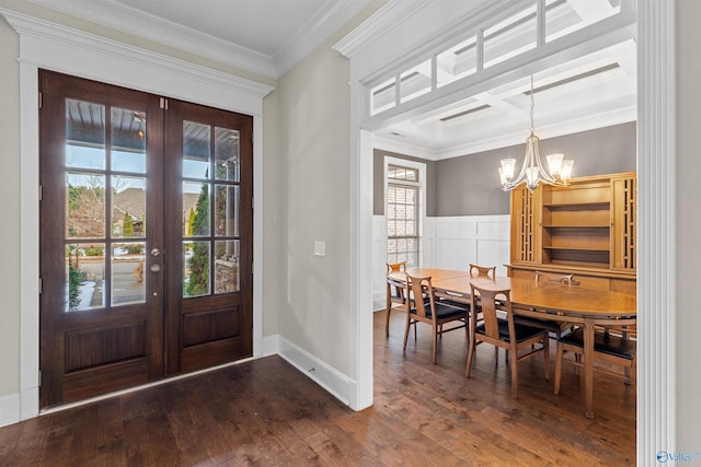 entrance foyer with an inviting chandelier, a wealth of natural light, crown molding, and french doors