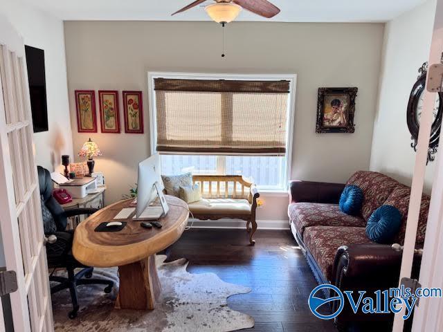 sitting room with baseboards, ceiling fan, and hardwood / wood-style flooring