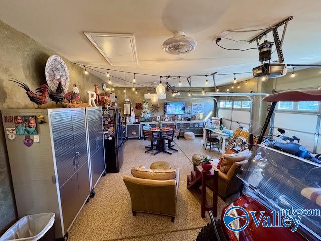 garage featuring a garage door opener and freestanding refrigerator