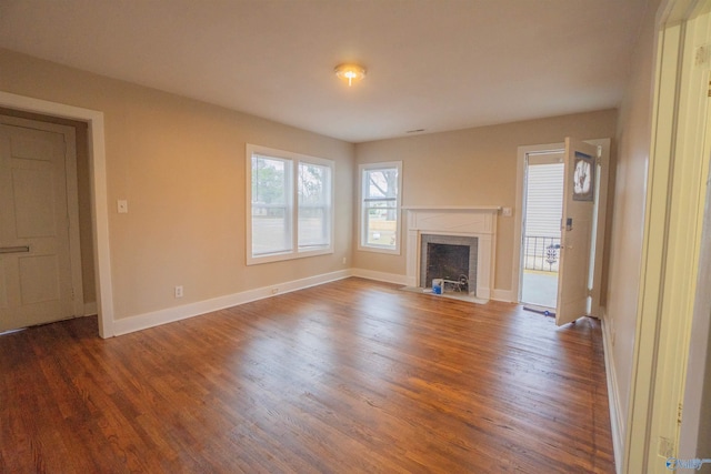 1014 7th Ave, Decatur, AL 35601 - unfurnished living room featuring wood finished floors and a fireplace with flush hearth