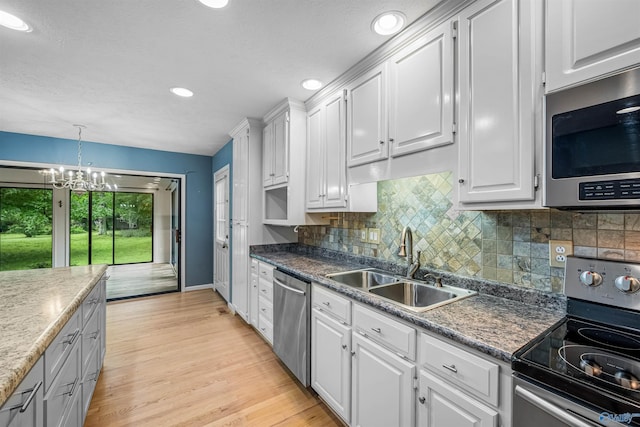 2211 Pumpkin Center Rd NE, Fort Payne, AL 35967 - kitchen with appliances with stainless steel finishes, a sink, white cabinetry, and recessed lighting
