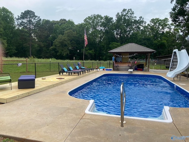 view of swimming pool with a patio, a water slide, and a gazebo