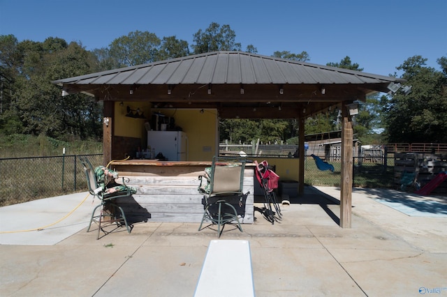 view of patio featuring a gazebo and a playground