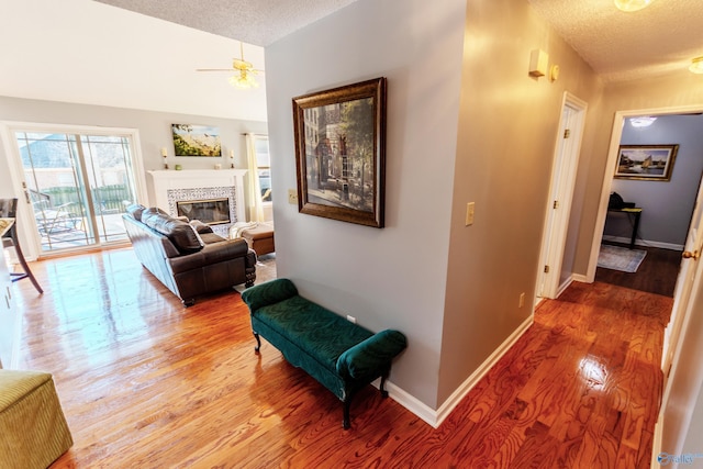 hallway with a textured ceiling and hardwood / wood-style flooring