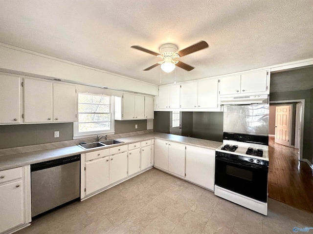 kitchen with gas range gas stove, dishwasher, sink, a textured ceiling, and white cabinets