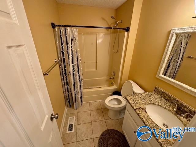 full bathroom featuring vanity, tile patterned floors, shower / bath combo, toilet, and a textured ceiling