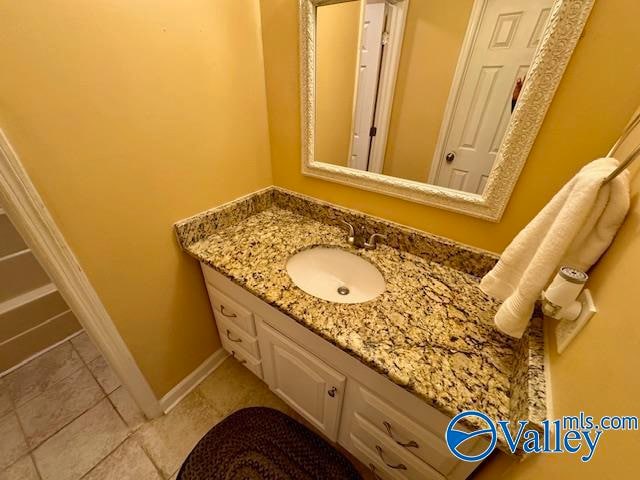 bathroom featuring tile patterned flooring and vanity