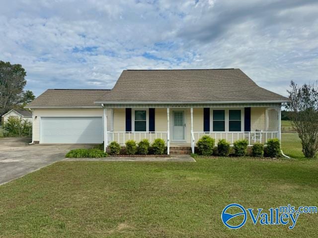 view of front of property featuring a front lawn, covered porch, and a garage