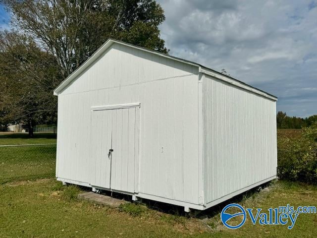 view of outbuilding featuring a lawn