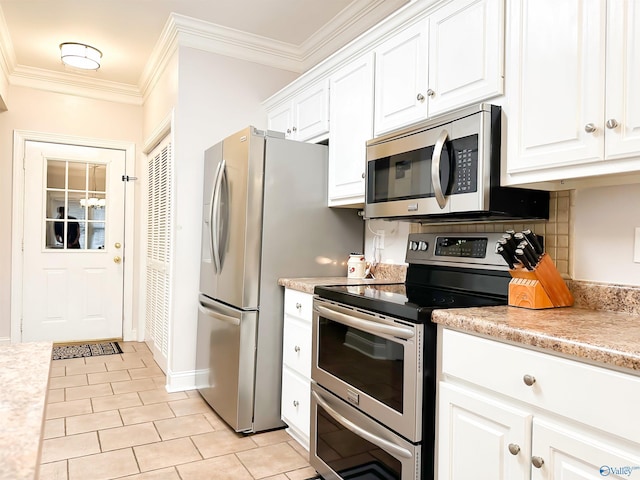 kitchen with ornamental molding, stainless steel appliances, light countertops, white cabinetry, and tasteful backsplash