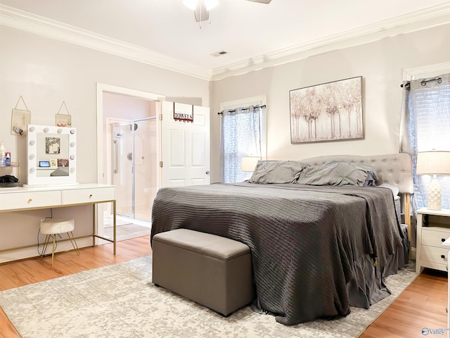 bedroom with visible vents, light wood-type flooring, ceiling fan, and ornamental molding