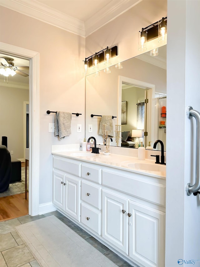 bathroom with ensuite bath, crown molding, and a sink
