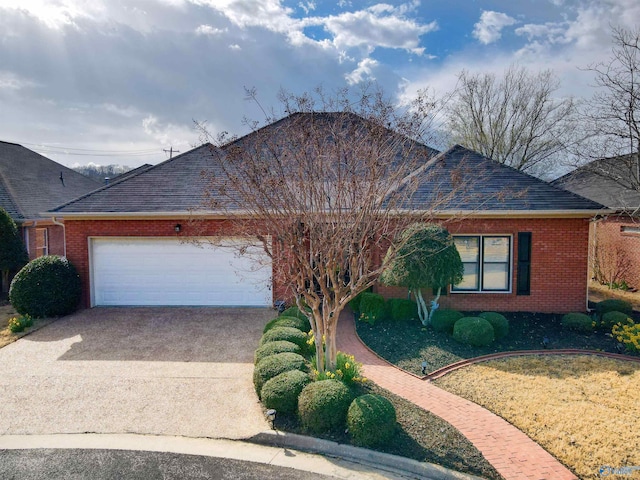 ranch-style house with an attached garage, brick siding, and driveway