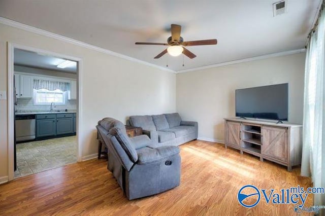 living room featuring crown molding, ceiling fan, sink, and light hardwood / wood-style flooring