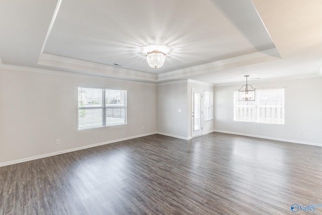 unfurnished room featuring ornamental molding, dark hardwood / wood-style floors, and a notable chandelier