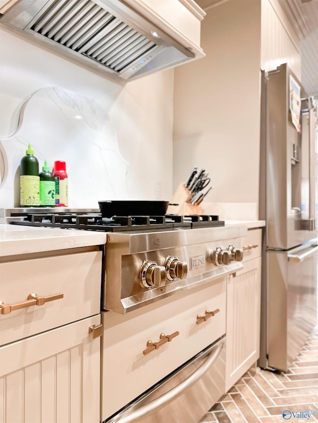 details with light countertops, freestanding refrigerator, and custom range hood