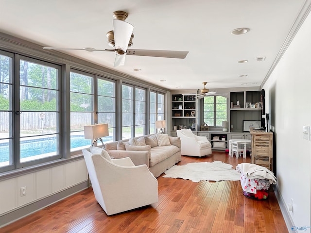 living room featuring wood finished floors, a ceiling fan, visible vents, and recessed lighting
