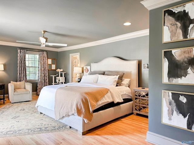 bedroom with wood finished floors, ceiling fan, and crown molding