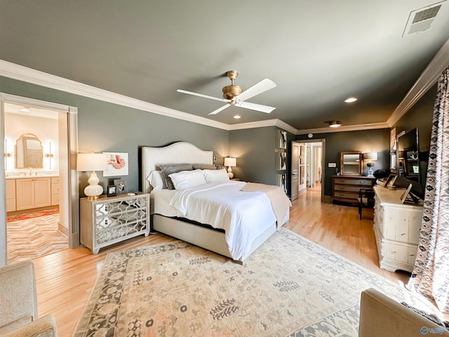 bedroom featuring crown molding, a sink, visible vents, and light wood-style flooring