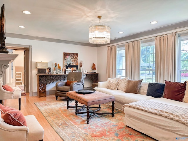 living room featuring recessed lighting, light wood finished floors, and a notable chandelier