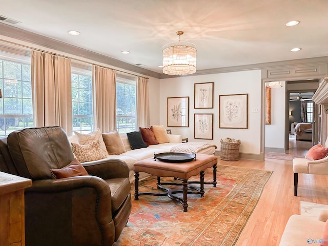 living room with recessed lighting, light wood-style flooring, visible vents, and a notable chandelier