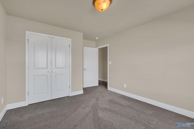 unfurnished bedroom with a closet and carpet