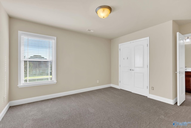 unfurnished bedroom featuring dark carpet