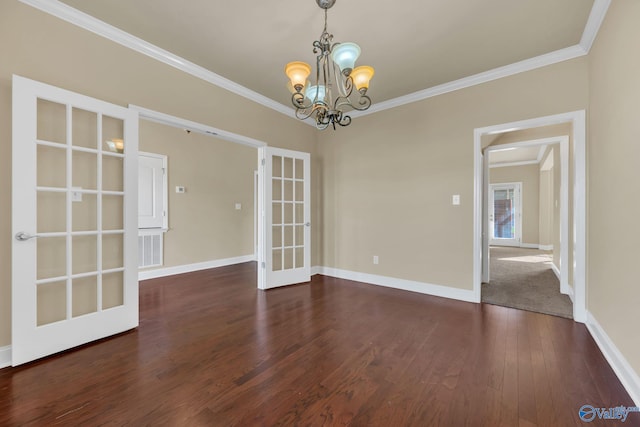 unfurnished dining area featuring ornamental molding, dark hardwood / wood-style floors, french doors, and an inviting chandelier