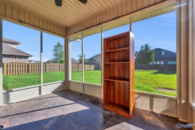 unfurnished sunroom with plenty of natural light and wood ceiling