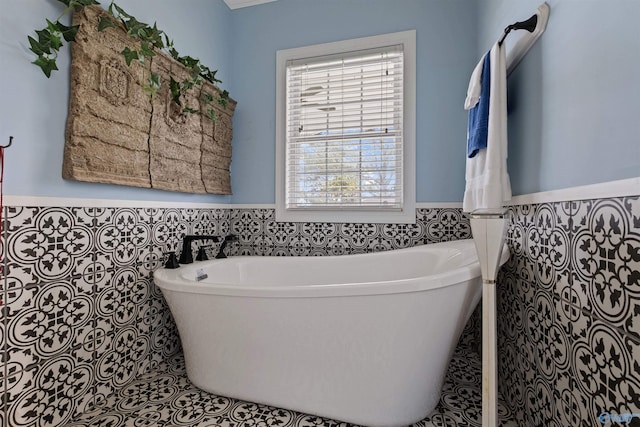 bathroom featuring tile walls, tile patterned flooring, and a bathtub