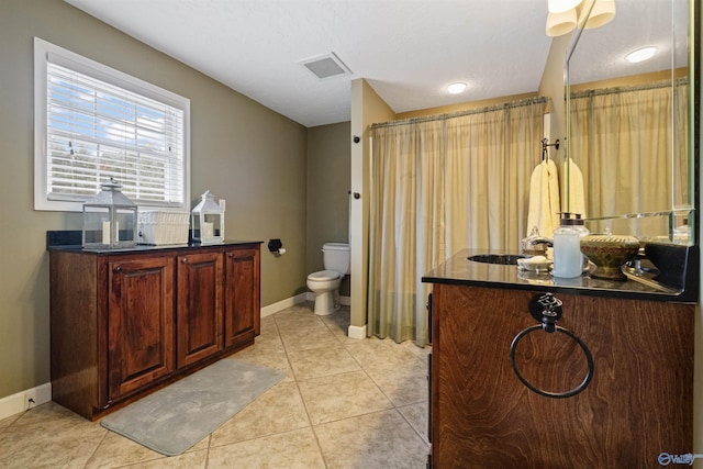 bathroom with tile patterned floors, toilet, and vanity