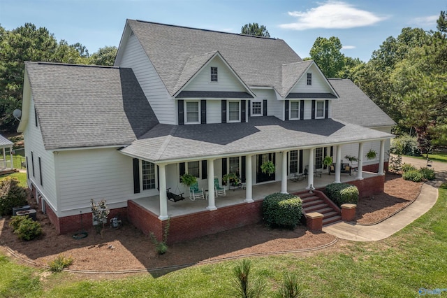 back of property featuring a lawn and a porch