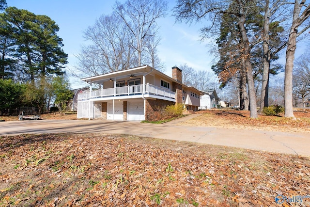 view of side of property with a garage and ceiling fan