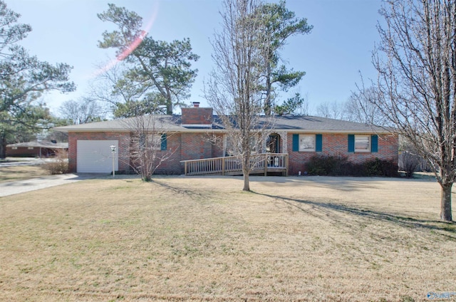 ranch-style home featuring brick siding, a chimney, an attached garage, driveway, and a front lawn