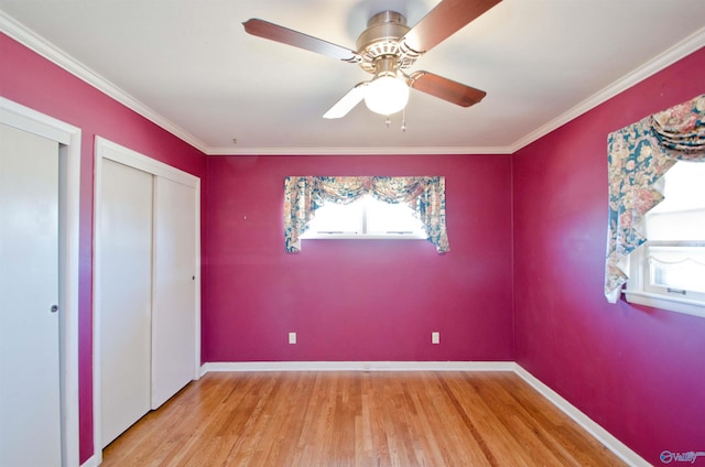 unfurnished bedroom featuring ornamental molding, wood finished floors, and baseboards