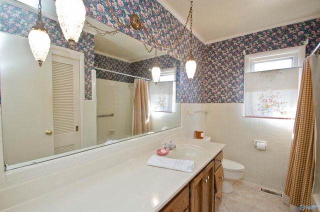 full bathroom featuring toilet, a wainscoted wall, tile walls, visible vents, and wallpapered walls