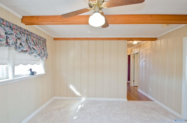 spare room featuring a ceiling fan, crown molding, baseboards, and beam ceiling