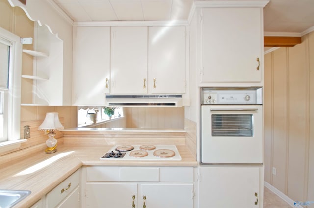 kitchen featuring white appliances, light countertops, under cabinet range hood, and white cabinetry