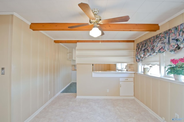 kitchen featuring built in study area, beamed ceiling, and open shelves