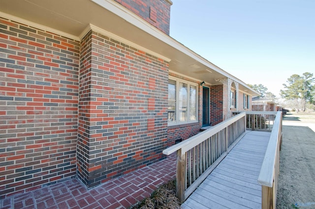 view of side of home with brick siding