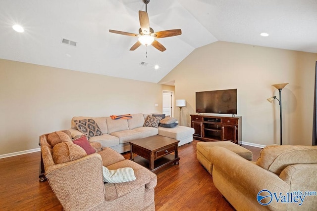 living room with visible vents, dark wood-type flooring, vaulted ceiling, ceiling fan, and baseboards