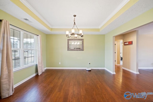 unfurnished room with dark wood-style floors, baseboards, visible vents, and a raised ceiling